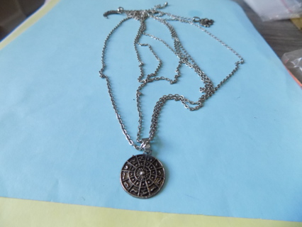 4 strand silvertone chain necklace, brass medallion dangle and crescent moon & elephant charm