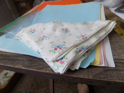 Stack of triangle cut material for quilt making tiny  pink, blue flowers & leavs