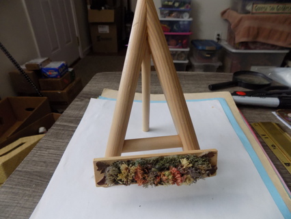 7 1/2 inch tall wooden easel with dried flowers in window box on front