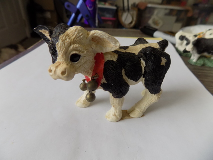 Resin black and white calf with red ribbon on neck & jingle bell white star on his rump
