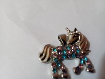 Silver unicorn over stainless steel with blue & purple jems