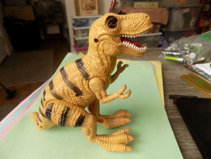 6 1/2 tall yellow dinosaur black stripes makes sounds, eyes light up