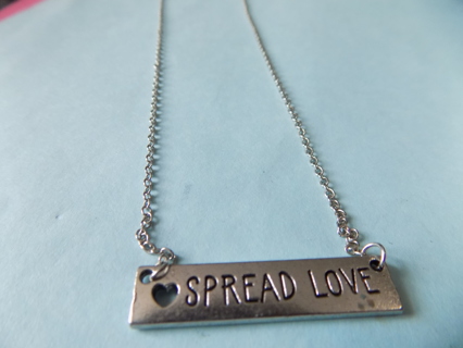 Necklace silvertone chain and bar charm says Spread Love