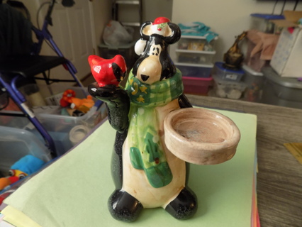 7 inch tall ceramic black bear candle holder has cardinal in hand