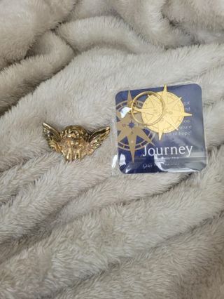 An angel pin and a star keychain