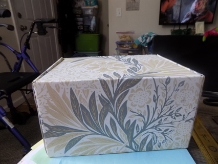 Flowered 9 x 7 x 6 gift box and blue crinkled filler paper inside