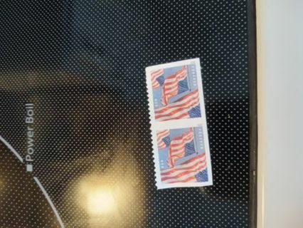 2 forever stamps with American flags on them