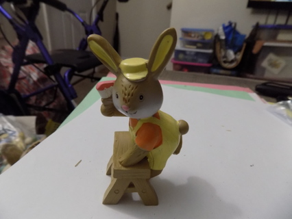 4 inch tall resin brown bunny on a ladder dressed in yellow & orange
