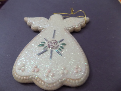 5 inch sparkly white angel ornament with rose painted on her chest and trim bottom