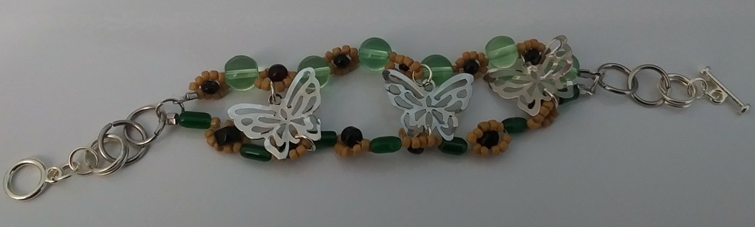 Silvertone bracelet. Butterflies and sunflowers. Toggle clasp. New.