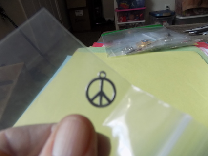 Silvertone peace sign charm inside a circle