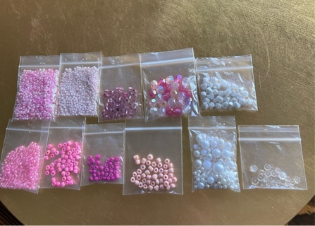 11 bags of pink and white beads for jewelry making and other crafts 