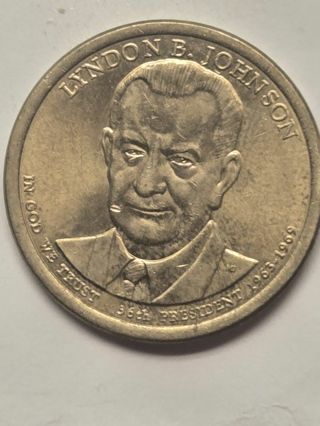 Gold colored one dollar coin Lyndon Johnson 36th president