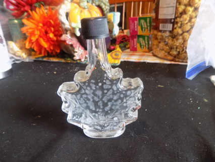 Clear glass maple leaf shaped bottle with black twist off lid