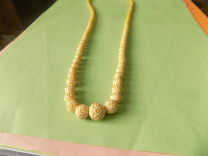 Vintage Necklace beads look like carved ivory mostly white, a few have yellowed with age