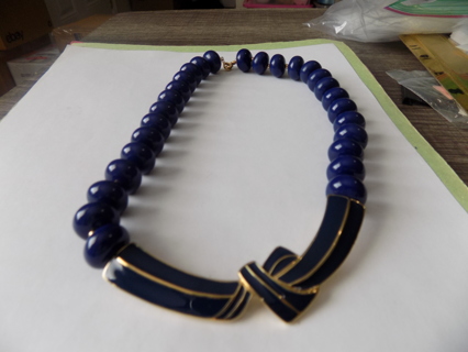 Vintage navy blue large bead necklace with enameled bow on front lobster catch