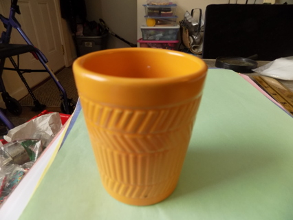 Orange ceramic drinking glass for bathroom with wavy lines texure