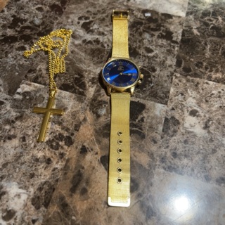 A watch with a cross necklace