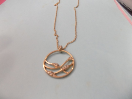 Necklace goldtone open circle dangle withe 2 curved lines inside, rhinestone accents