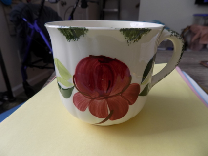 Vintage ceramic ribbed coffee cup with red painted flowers, green leaves