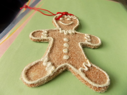 4 1/2 tall crystalized resin gingerbread man cookie ornament red bow on head