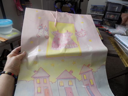 Jumbo gift bag for baby girl shower has baby clothes on line 22 x 15