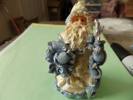 4 inch Father Christmas figurine dressed in blue & white holds wreath and hiking stick