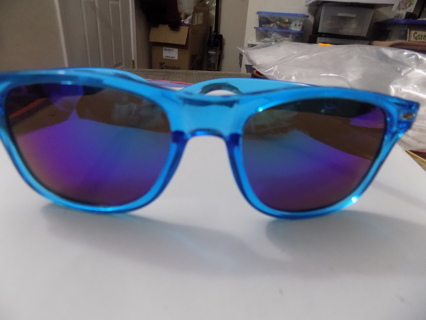 Blue sunglasses with bluish green dark lenses