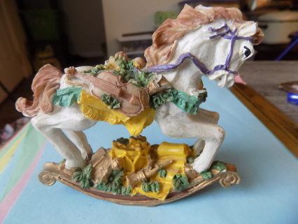 Resin 5 inch rocking horse. hasviolin on saddle harp, horn on other side, presents very detailed