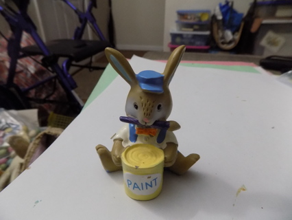 4 inch tall resin bunny sitting down dressed in blue holds yellow paint can