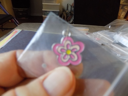 @ shades of pink enamel 5 petal flower charm with yellow center