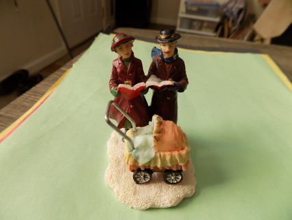 3 1/2 inch resin Mother & Father caroling with baby carriage with them