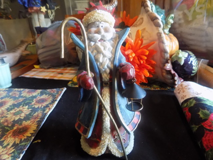9 inch tall resin Santa in blue coat trim in red plaid Holds lantern and shepherds crook