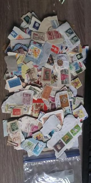 HUNDREDS OF FOREIGN USED STAMPS ON PAPER!