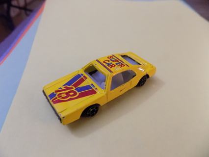 Diecast yellow Super car with # 18 and blue & red stripes on hood