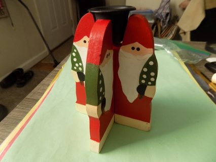 Wooden 4 hand painted Santa's fit together to form taper candle holder with black cup