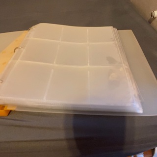 Small binder with (25) 9 pocket plastic pages (used)