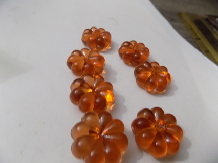 Set of 7 orange multi petal flower shaped embellishments