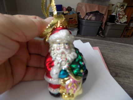 4 inch resin Santa ornament looks like its glass holds toy bag