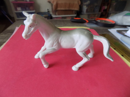 4 1/2 inch long hard plastic white stallion with smoky gray down back & tail