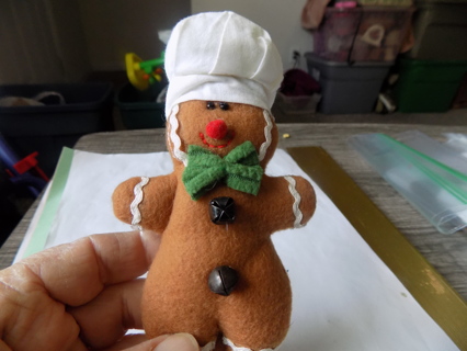 5 1/2 tal felt gingerbread baker boy oranent in chef hat green bow, jingle bells,