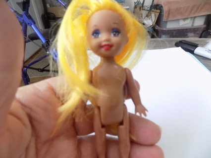Sun tanned Kelly doll Barbie's little sister, bright yellow hair
