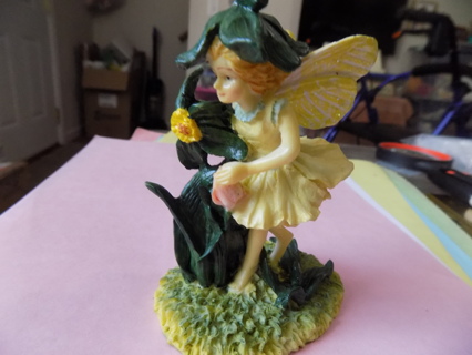 4 inch tall yellow fairy figurine in green leaf hat