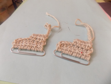 Pair of hand crocheted ice skate ornaments with paperclip metal runners