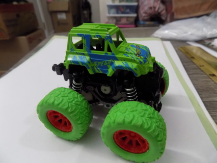 3 1/2 tall green Monster truck on lime green big tires on springs