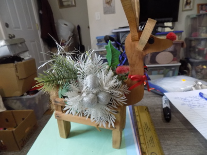 Wooden home made reindeer baseket of Christmas flowers