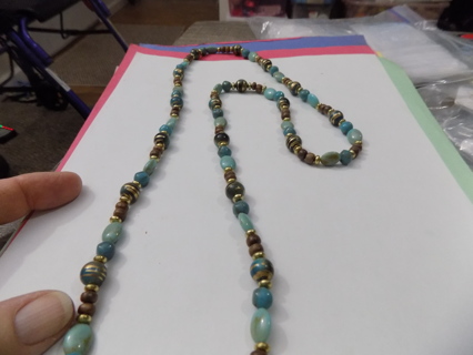 Necklace light blue, dark blue browns and gold beads and gold striped ones