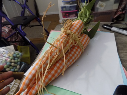 14 inch set of 3 orange and white checkered carrots Raffia ribbon tied together, ribbon & leaves