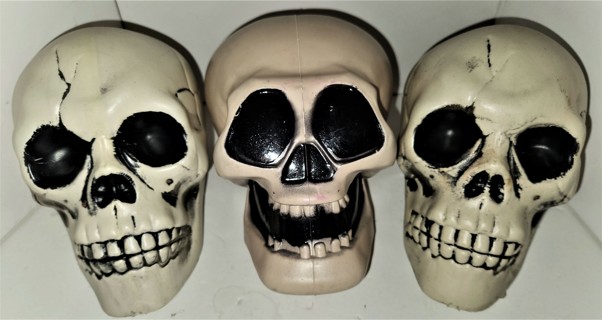 3 plastic hollow Halloween Skulls - size 7" x 4 1/2" x 4" - total weight 6 oz.