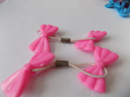 Pair of pink bow ponytail holders